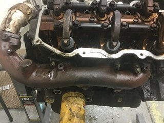 View of the exhaust manifold (I know the valve cover is off, had to remove that to get engine out).